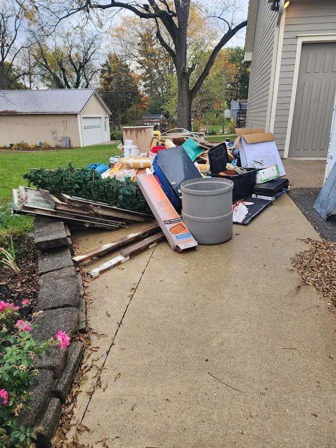 Dumpster being loaded with debris for Estate Cleanout Dumpster Rental in Childress
